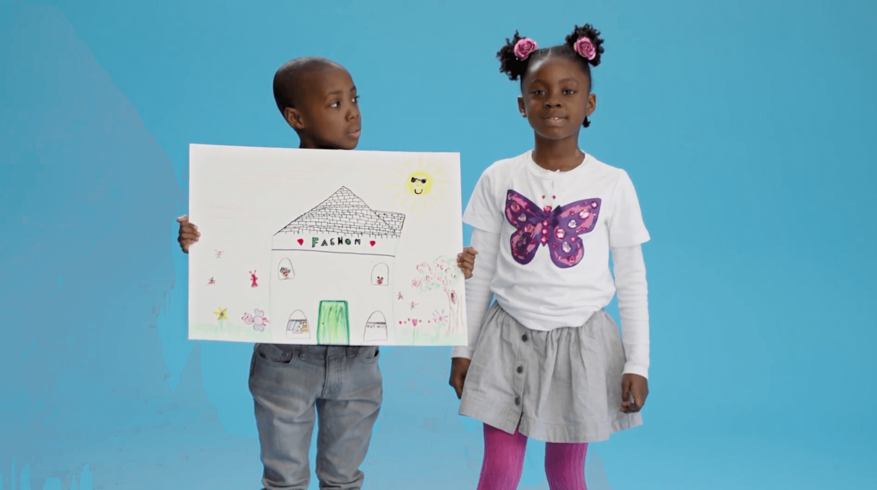 boy holding drawing looking at girl